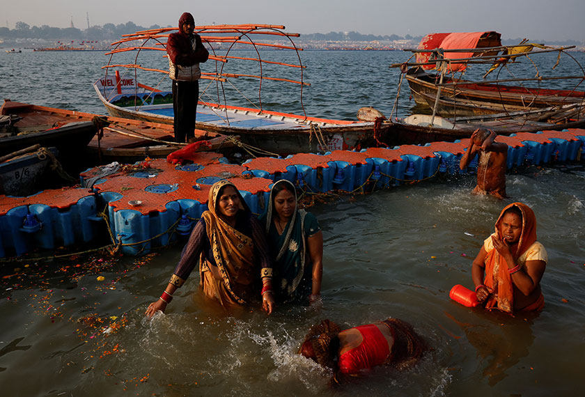 Devotees take a holy dip at Sangam, the confluence of the Ganges and Yamuna rivers with the mythical, invisible Saraswati river, during the 