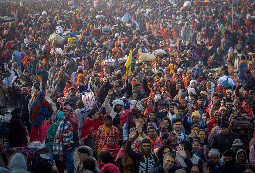 Devotees arrive at the river bank to take a holy dip at Sangam, the confluence of the Ganges and Yamuna rivers with the mythical invisible Saraswati river, during the 