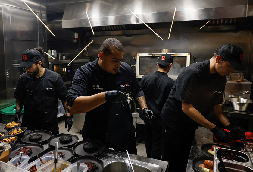 Spain's viral chef Elias Dosunmu with over 20 million followers across all of his social media cooks in his restaurant in Madrid, Spain. - REUTERS