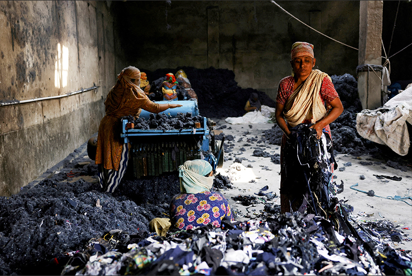 Women work in a factory where fabric waste from garments is transformed into cotton to make mattresses, in Narayanganj, Bangladesh, February 5, 2025. - REUTERS