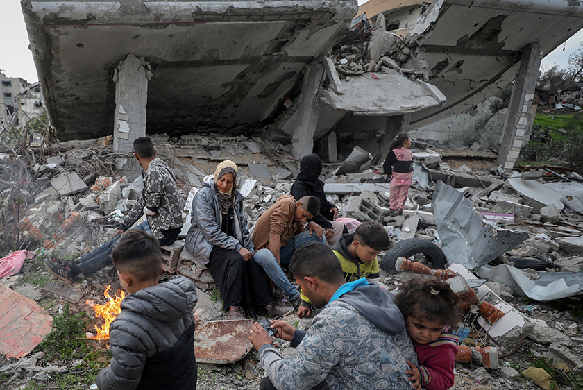 Ismael Mohammed, 47, and his family, who were displaced to the southern part of Gaza at Israel's order during the war, gather at the rubble of their destroyed house after returning amid a ceasefire between Israel and Hamas, in Jabalia. - REUTERS