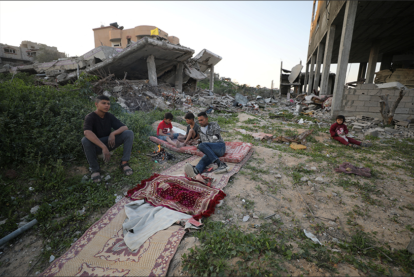Naseem, 22, and Mohammed, 5, who were displaced with their family to the southern part of Gaza at Israel's order during the war, search for their belongings amongst the rubble of their destroyed house, in Jabalia. - REUTERS