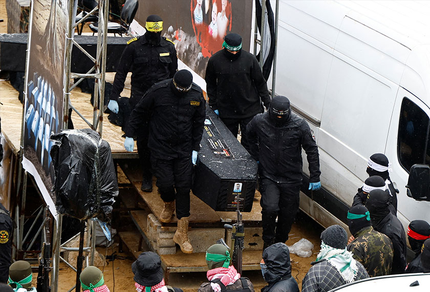 Palestinian forces carry a coffin on the day Hamas hands over deceased hostages Oded Lifschitz, Shiri Bibas and her two children Kfir and Ariel Bibas, seized during the deadly October 7, 2023 attack, to the Red Cross, as part of a ceasefire and hostages-prisoners swap deal between Hamas and Israel, in Khan Younis in the southern Gaza Strip February 20, 2025. - REUTERS
