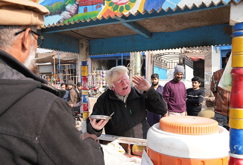Saleem Bagga, seen by some as a lookalike of U.S. President-elect Donald Trump, sings songs while selling kheer, a traditional South Asian rice pudding, along a road in Sahiwal, Pakistan. - REUTERS