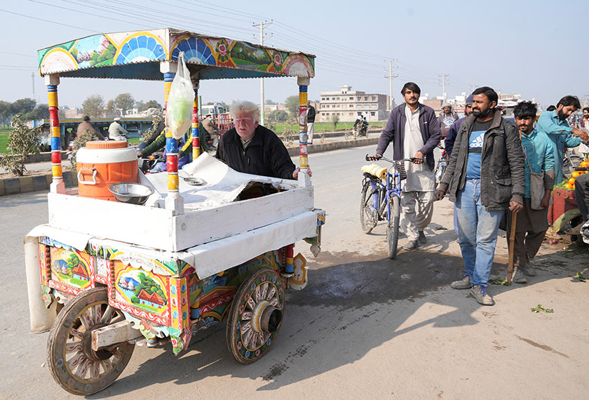 Saleem Bagga, seen by some as a lookalike of U.S. President-elect Donald Trump, pushes his cart while selling kheer, a traditional South Asian rice pudding, along a road in Sahiwal, Pakistan. - REUTERS