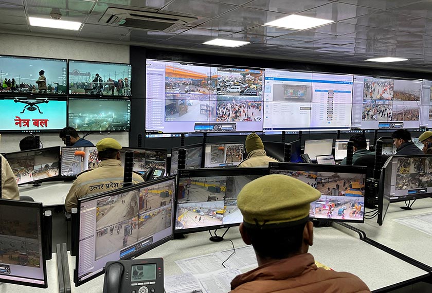 Police officers monitor screens at the Integrated Command and Control Center which is set up to manage and control the crowd during the ongoing 