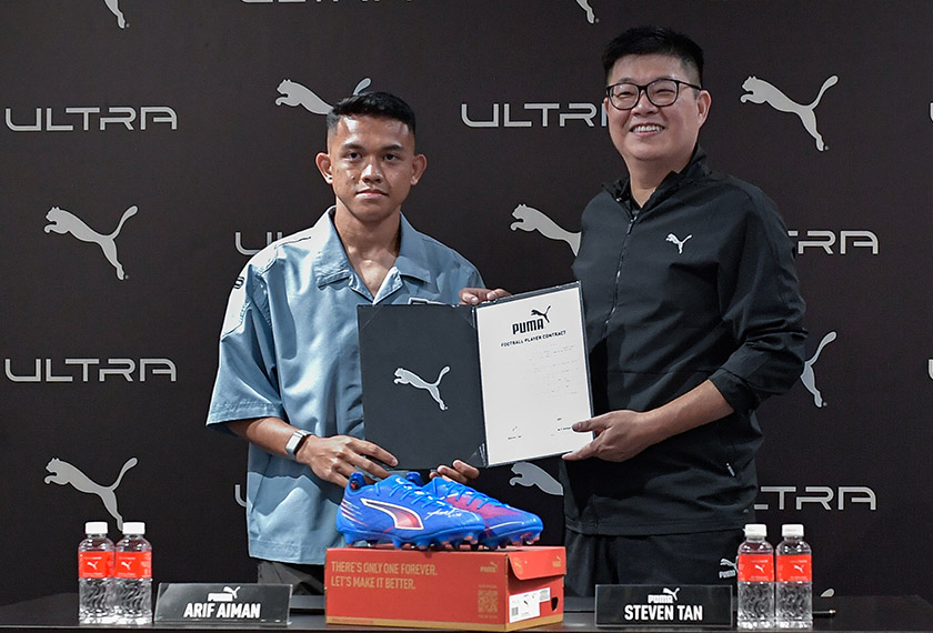 Arif Aiman Mohd Hanapi (kiri) bersama Pengurus PUMA Malaysia, Steven Tan pada Majlis Menandatangani Perjanjian Rasmi Duta Bola Sepak Terbaharu PUMA di PUMA Store Sunway Pyramid hari ini. - Foto Bernama