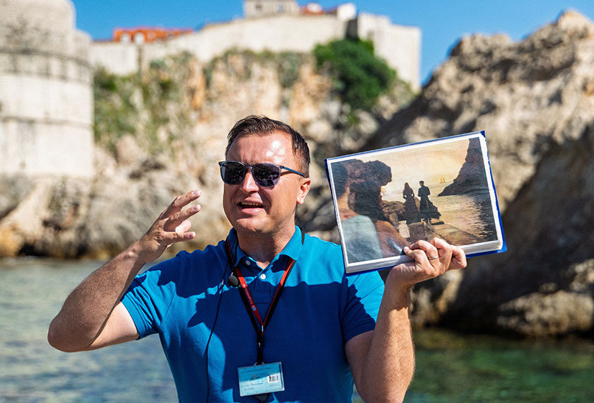 A tourist guide shows a frame from the TV series Game of Thrones on a tourist tour in Dubrovnik, Croatia. - REUTERS/Antonio Bronic
