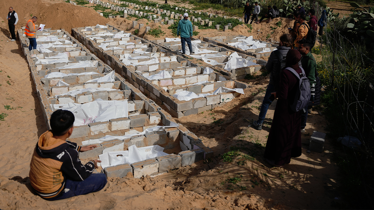 Bodies of unidentified Palestinians returned from Israel as part of the ceasefire deal are buried in Deir al-Balah, Gaza Strip, Friday, Feb. 13, 2026. (AP Photo/Abdel Kareem Hana)