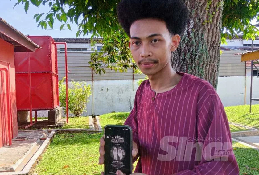 Anak ketiga mangsa, Mohd Aiman menunjukkan gambar ibu bersama adiknya.