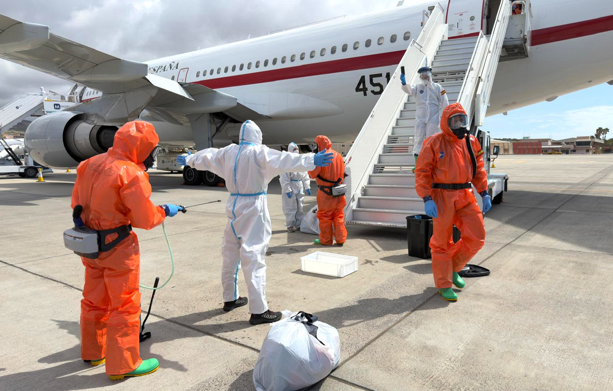 A Spanish passenger is sprayed with disinfectant by Spanish government officials before boarding a plane after disembarking from the hantavirus-stricken cruise ship MV Hondius at Tenerife airport in the Canary Islands, Spain, Sunday, May 10, 2026. (AP Photo)
