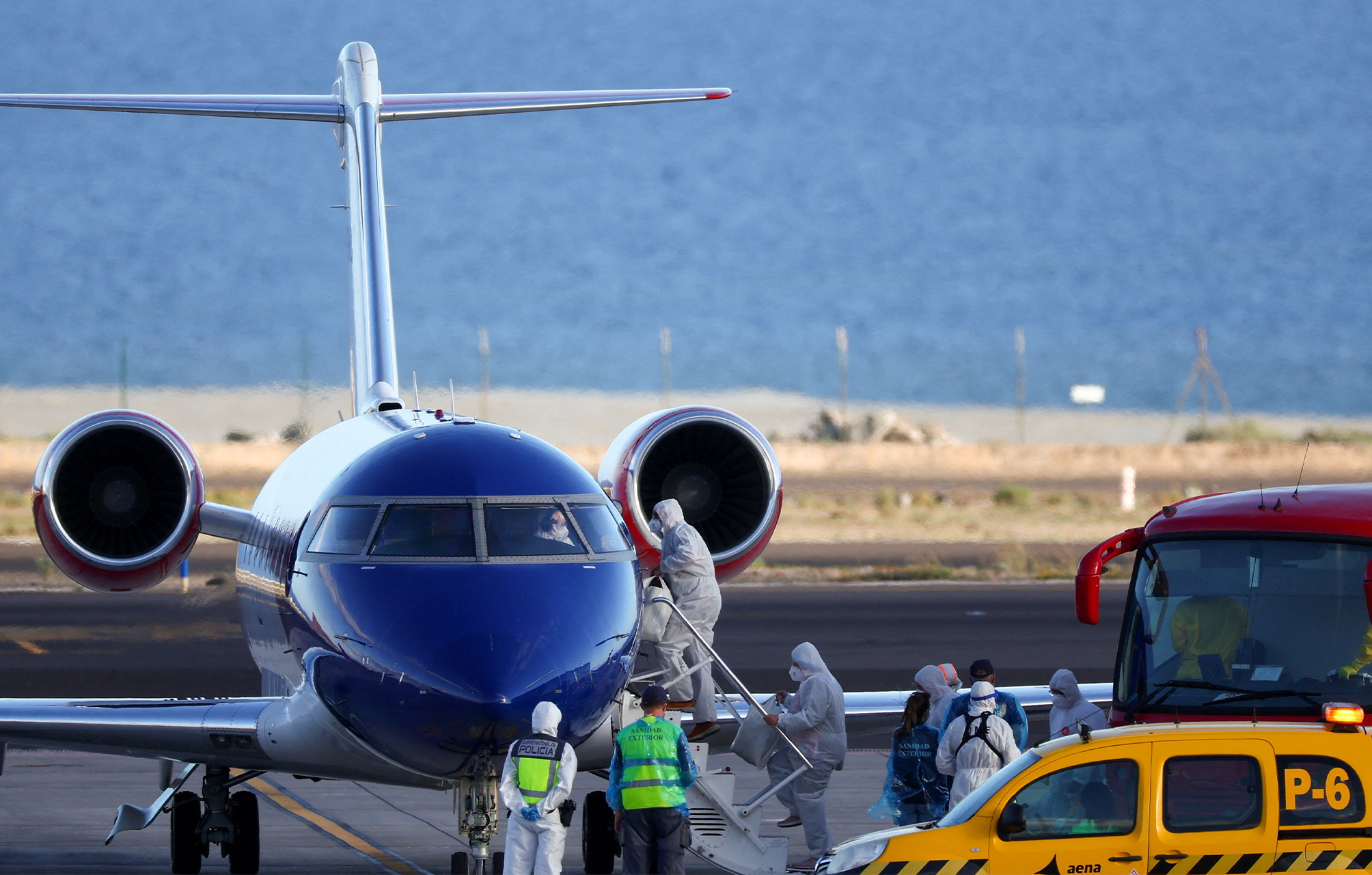 Passengers from the cruise ship MV Hondius, which was affected by a hantavirus outbreak, board a plane flying to the Netherlands, at Tenerife Sur airport, Canary Islands, Spain, May 11, 2026. REUTERS/Pedro Nunes