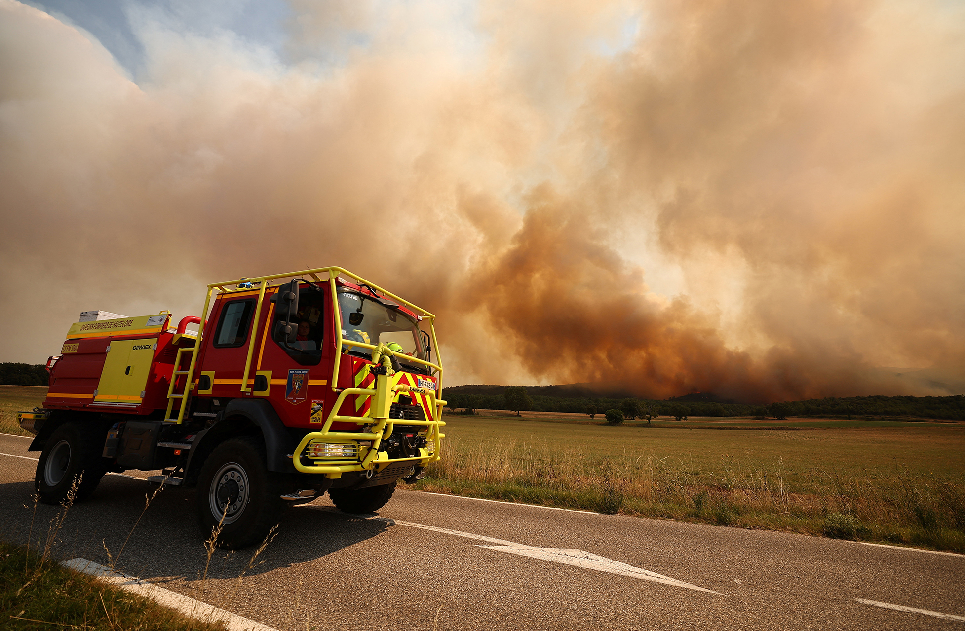A fire truck drives as French firefighters battle a wildfire in the Fox-Amphoux communal forest near Ponteves in the Var department, as drought conditions worsen following a heatwave and water shortages across much of France, July 21, 2026. REUTERS/Manon Cruz