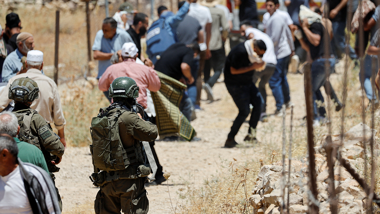 An Israeli soldier uses tear gas against Palestinians as they hold Friday prayers during a protest against Israeli settlement expansion and land confiscation near Bethlehem in the Israeli-occupied West Bank, July 3, 2026. REUTERS/Mussa Qawasma
