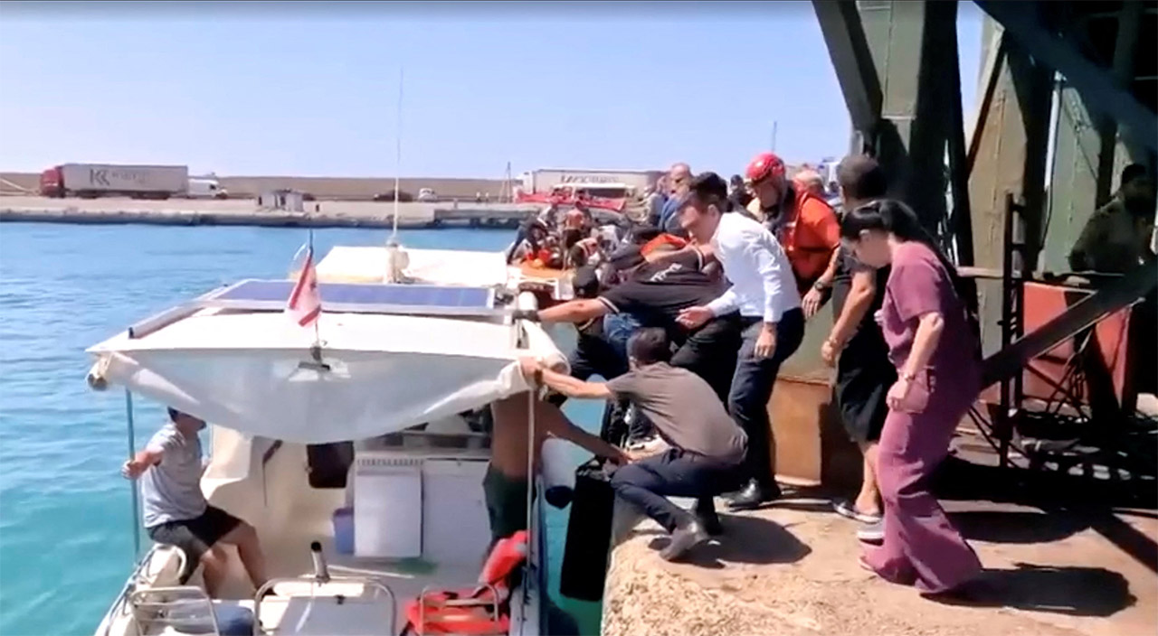 Rescue boats bring passengers to shore from capsized boat in northern Cyprus, August 30, 2026 in this screengrab taken from a video. REUTERS/Reuters TV