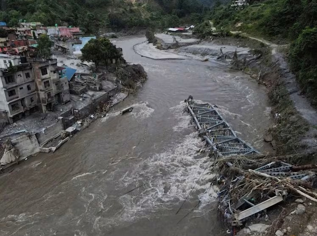 Drone view of a broken bridge and damaged houses after flash floods and a mudslide in Devighat, Nuwakot District, Nepal, Aug 28, 2026. (Photo: Reuters/Francis Mascarenhas)
